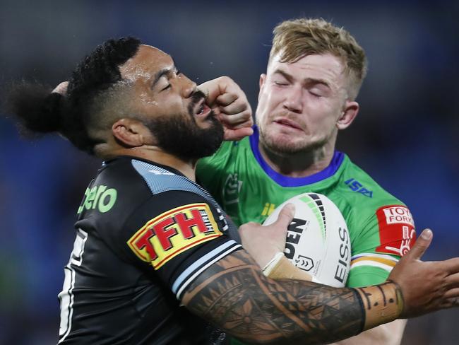 GOLD COAST, AUSTRALIA - JULY 17:  Hudson Young of the Raiders puts a fend on Siosifa Talakai of the Sharks during the round 18 NRL match between the Canberra Raiders and the Cronulla Sharks at Cbus Super Stadium, on July 17, 2021, in Gold Coast, Australia. (Photo by Regi Varghese/Getty Images)