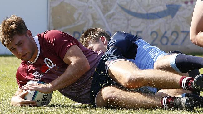 QLD Reds' Xavier Rubens gets over the line for a try in the annual battle between the Tahs and Reds. Picture: John Appleyard