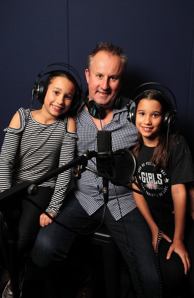 Jay Walkerden, with twin daughters Holly and Amelia, has launched his own podcasting company, Podshape, out of a home studio in Brisbane. Picture: AAP Image/Josh Woning