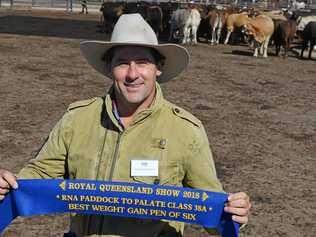 PADDOCK TO PLATE: Wallumbilla's Andrew Bassingthwaighte with one of three ribbons his team picked up. Picture: Michael Doyle