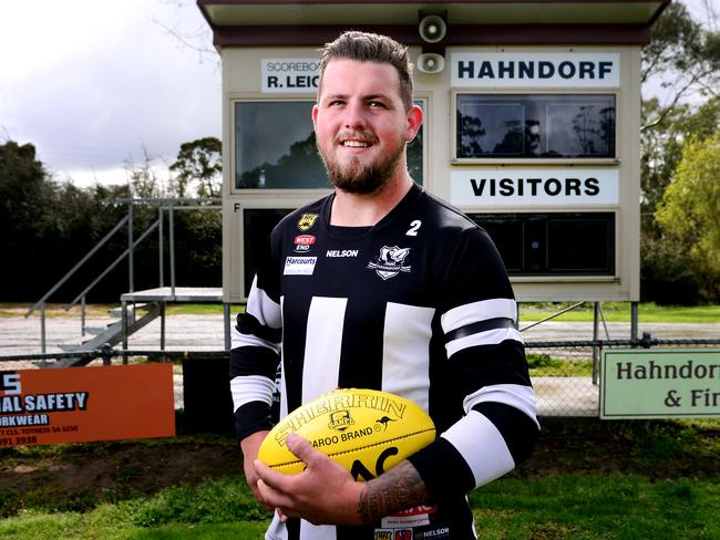 Darcy Hourigan who has kicked 100 goals for Hahndorf this season poses on the Hahndorf Oval wearing a  black armband for his brother who died suddenly a few years ago.Saturday September 1,2018.(Image AAP/Mark Brake)