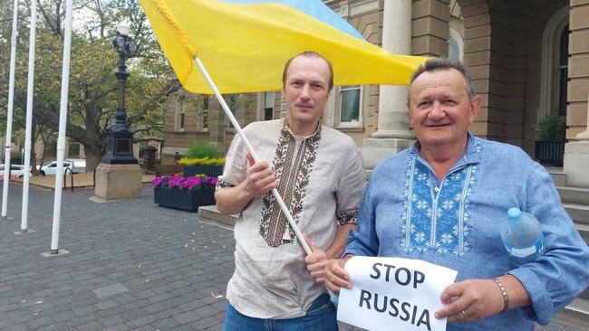 Ukraine-born Oleksandr Tkachuk and Zac Baltic, whose wife is Ukrainian, at a protest outside Hobart Town Hall against Russian military operation. Picture: Annie McCann.