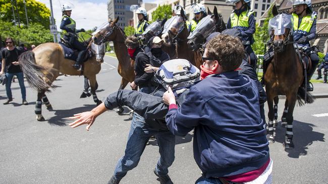 Protesters scuffle outside Parliament House. Picture: Eugene Hyland