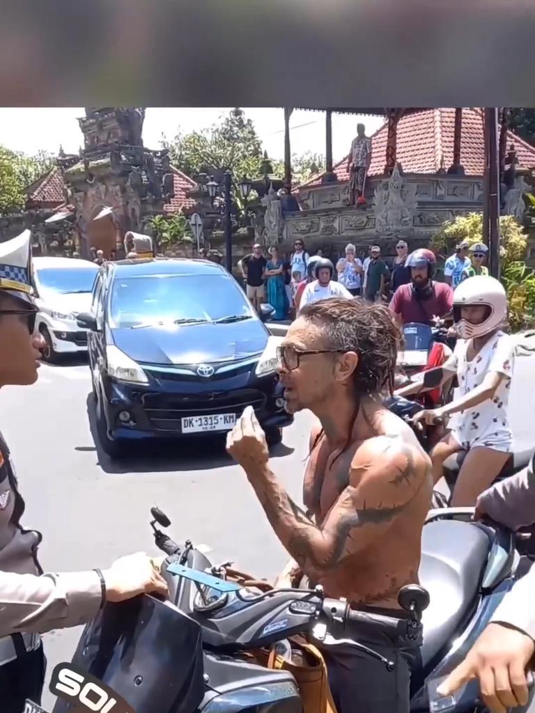 The shirtless tourist, speaking with a North American accent, protests being stopped and claimed officers were allowing Balinese locals to do the same thing. Picture: Supplied