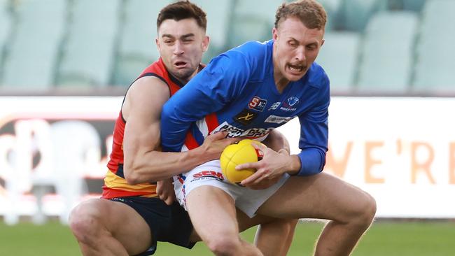 Crow Brett Turner tackles Central District’s Rhett Montgomerie at Adelaide Oval on Saturday. Picture: SANFL Image / James Elsby