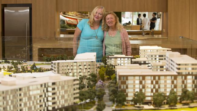 Public-private mix public housing in Riverwood Estate has been praised by the Greater Sydney Commission. Pictured are residents of the Washington Park precinct with a model of what the area will look like.