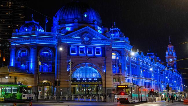 Flinders Street Station lights up in a show of support for Victoria Police. Picture: Mark Stewart