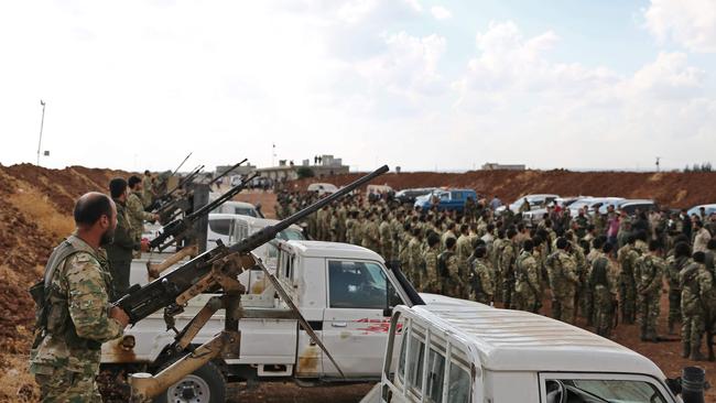 Turkish-backed Syrian rebel fighters gather near the Syrian-Turkish border north of Aleppo on October 7, 2019. — US forces in northern Syria started pulling back from areas along the Turkish border ahead of a feared military invasion by Ankara that Kurdish forces say would spark a jihadist resurgence. Picture: AFP