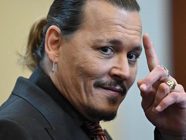 (FILES) In this file photo taken on May 3, 2022 US actor Johnny Depp looks on during a hearing at the Fairfax County Circuit Courthouse in Fairfax, Virginia. - A US jury found June 1, 2022 that actress Amber Heard had made defamatory claims of abuse against her ex-husband Johnny Depp, and awarded him $15 million in damages. (Photo by JIM WATSON / POOL / AFP)