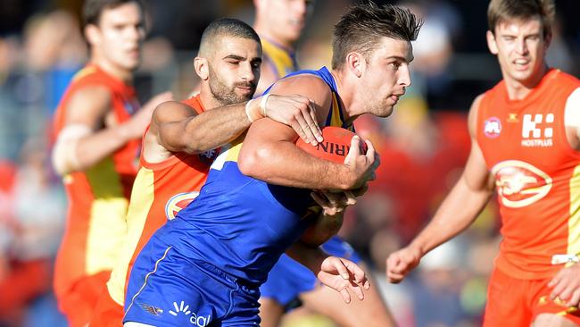 Adam Saad tackles Elliot Yeo at Metricon Stadium.