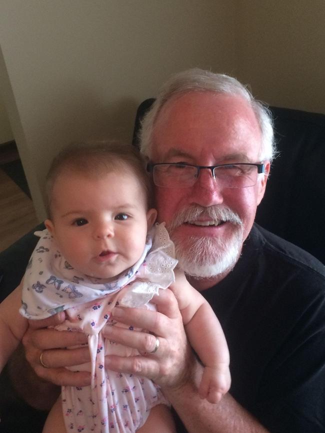 Nigel Harris with his granddaughter Evelyn. The 60-year-old was tragically killed when a vehicle veered off the road and into spectators at the Finke Desert Race on 14 June. Picture: Facebook.