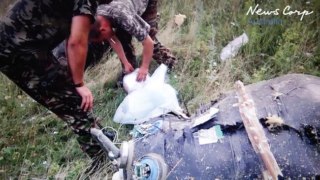 Searching for clues ... Rebels search the crash site to identify the plane. Picture: Supplied