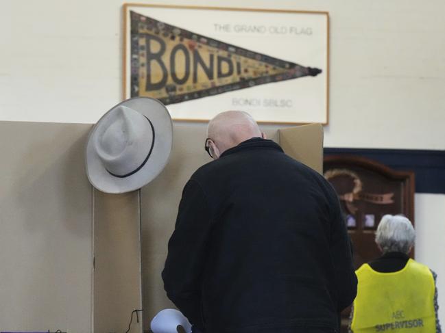 Some like to vote with their hat off. (AP Photo/Mark Baker)