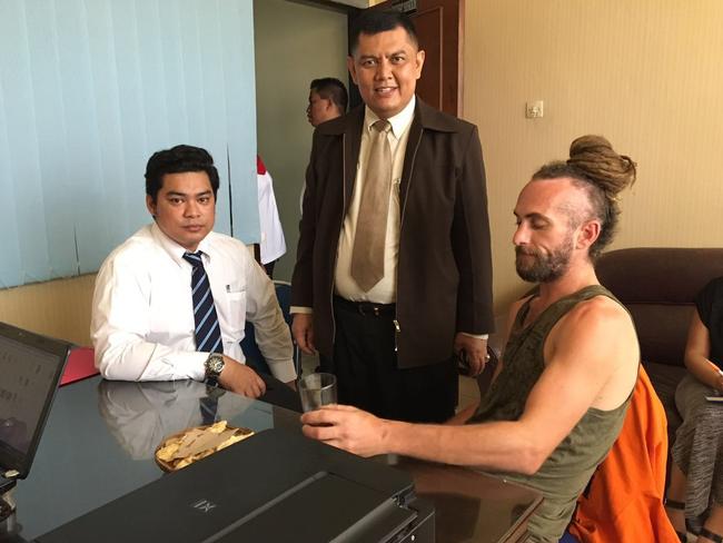 British man David Taylor inside a police office this morning in Bali with his lawyers. Picture: Supplied