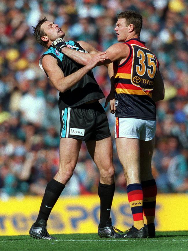 Port Adelaide’s Matthew Primus tangles with Adelaide’s Rhett Biglands in Showdown XII match at AAMI Stadium in 2002.