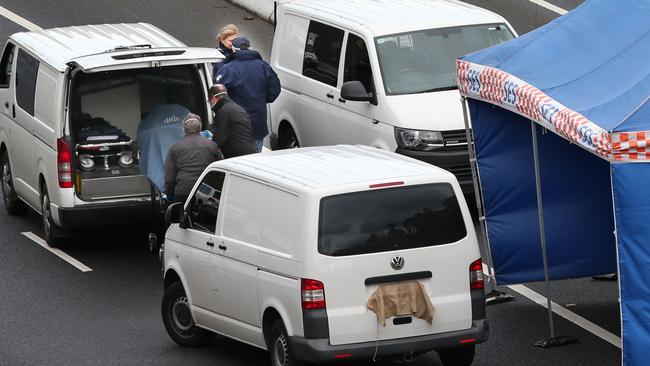 Police and emergency services on EastLink after the shooting. Picture: David Crosling