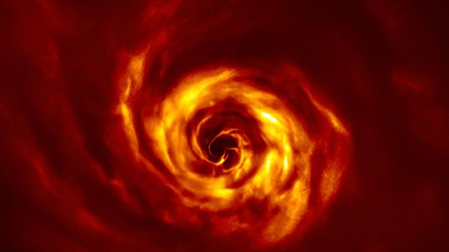 The swirling disc around the young AB Aurigae star in the Mily Way, where astronomers have spotted tell-tale signs of a baby planet being born. Close to the centre of the image is the ‘twist’ (in very bright yellow) that scientists believe marks the spot where a planet is forming. Picture: AFP