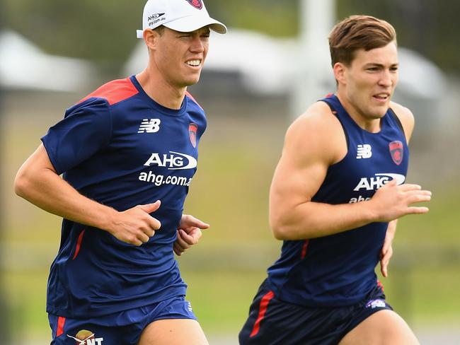 Jack Viney (right) hits the track for pre-season training with Jake Melksham.