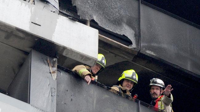 Fire crews inspect damage to the tower. Picture: Andrew Henshaw