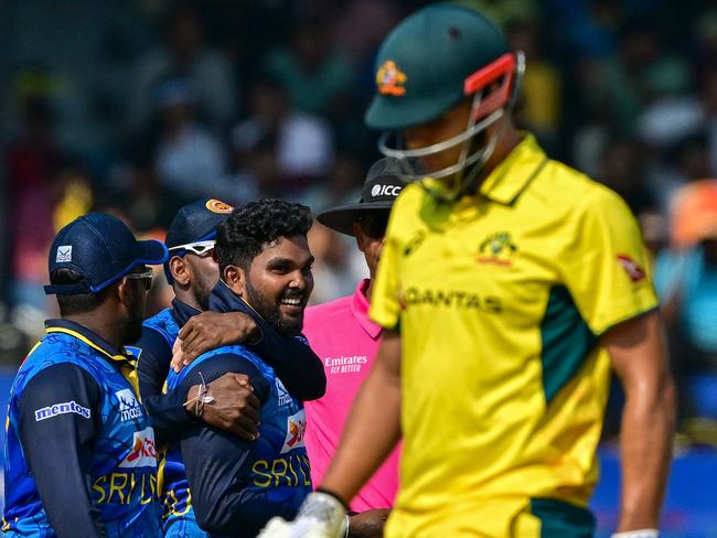 Sri Lanka's Wanindu Hasaranga celebrates with teammates after taking the wicket of Australia's Aaron Hardie. Picture: AFP