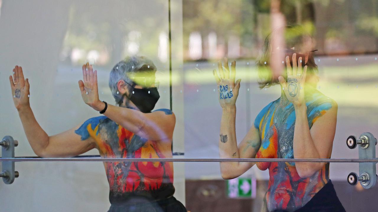 Extinction Rebellion protesters targeting the Independent Planning Commission at their Elizabeth St building in Sydney, with some protesters glueing their hands to the glass windows inside the foyer. Picture: Toby Zerna