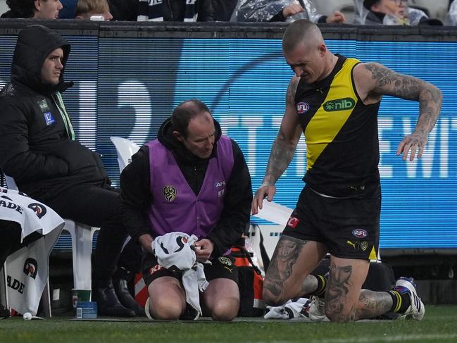 MELBOURNE, AUSTRALIA - JUNE 30: Dustin Martin of the Tigers receives medical attention on his back during the round 16 AFL match between Richmond Tigers and Carlton Blues at Melbourne Cricket Ground, on June 30, 2024, in Melbourne, Australia. (Photo by Daniel Pockett/Getty Images)
