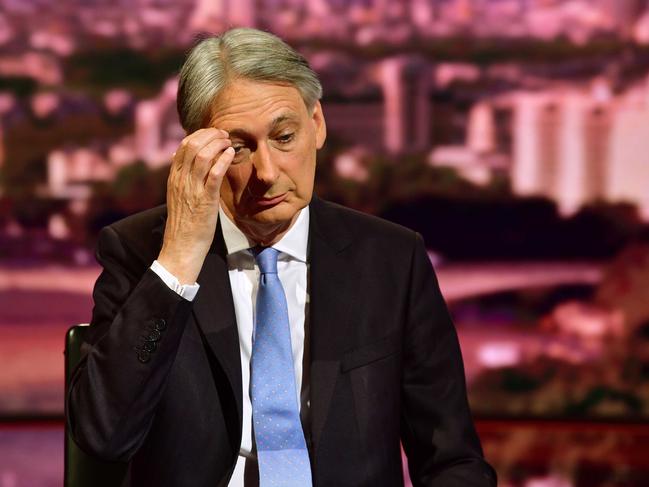 In this handout photograph received from the BBC on July 21, 2019, Britain's Chancellor of the Exchequer Philip Hammond gestures during a televsion interview at the BBC studio in London. - British finance minister Philip Hammond said Sunday he would make a point of resigning before Boris Johnson became prime minister, saying he could never agree to his Brexit strategy. (Photo by JEFF OVERS / various sources / AFP) / RESTRICTED TO EDITORIAL USE - MANDATORY CREDIT " AFP PHOTO / JEFF OVERS-BBC " - NO MARKETING NO ADVERTISING CAMPAIGNS - DISTRIBUTED AS A SERVICE TO CLIENTS TO REPORT ON THE BBC PROGRAMME OR EVENT SPECIFIED IN THE CAPTION - NO ARCHIVE - NO USE AFTER **ISSUE DATE + 21 DAYS** /