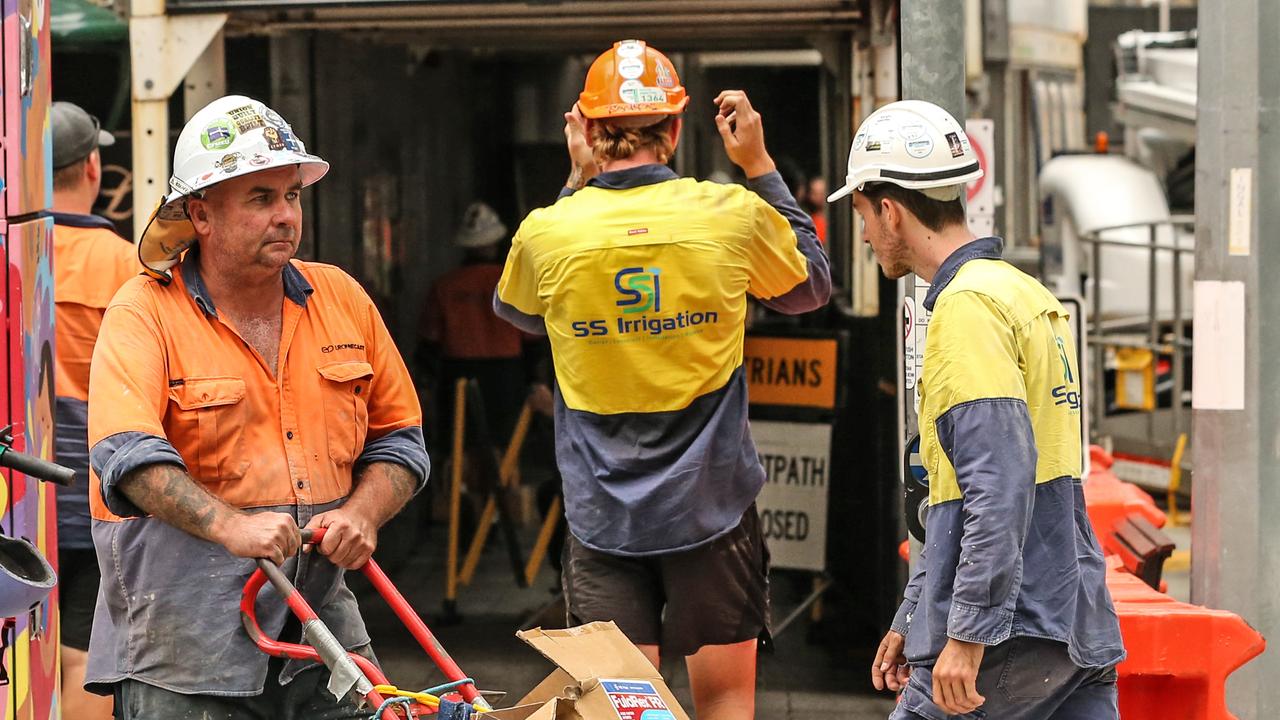 Workers leave the Probuild worksite on 443 Queens Street. Picture: Zak Simmonds