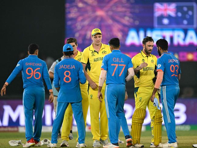 India's (in blue) and Australia's players greet each other at the end of the 2023 ICC Men's Cricket World Cup one-day international (ODI) final match between India and Australia at the Narendra Modi Stadium in Ahmedabad on November 19, 2023. (Photo by Sajjad HUSSAIN / AFP) / -- IMAGE RESTRICTED TO EDITORIAL USE - STRICTLY NO COMMERCIAL USE --