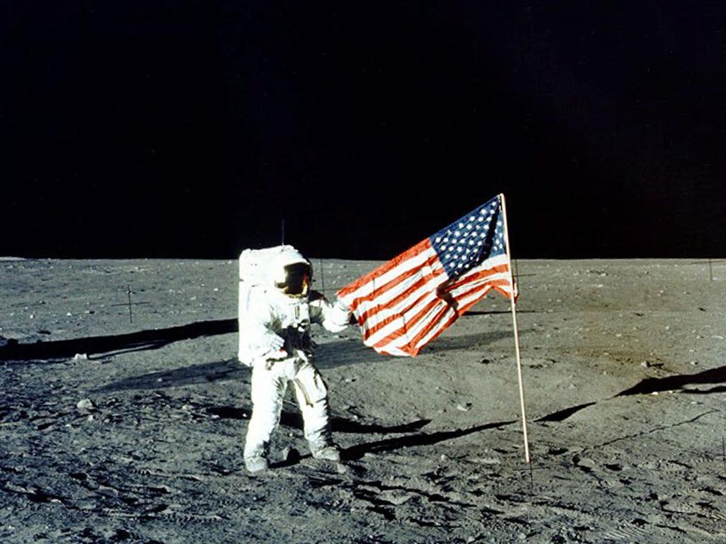 FILE - In this Nov. 1969 photo made available by NASA, Apollo 12 mission Commander Charles P. "Pete" Conrad stands on the moon's surface. A poll released Thursday, June 20, 2019 shows that Americans prefer a space program focusing on potential asteroid impacts, scientific research into our cosmos and robotic space probes over human exploration of Mars or the moon. (AP Photo/NASA)