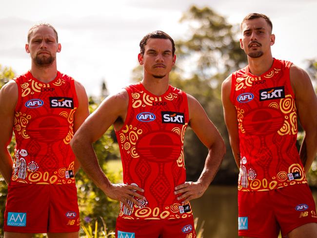 Gold Coast Suns players Jy Farrar, Daniel Rioli and Joel Jeffrey model the club's 2025 Indigenous guernsey to be worn in round 11 against St Kilda. Photo: Gold Coast Suns
