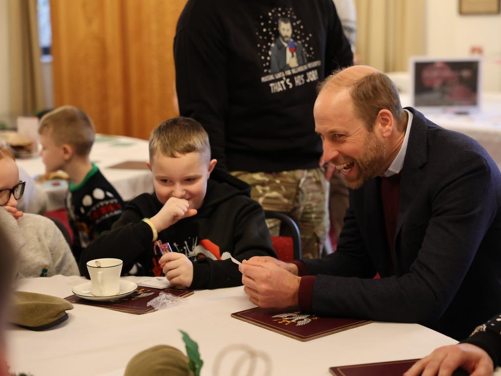 Elsewhere around the world: Prince William jokes around with kids during a visit to Picton Barracks. Picture: Richard Pohle - WPA Pool/Getty Images