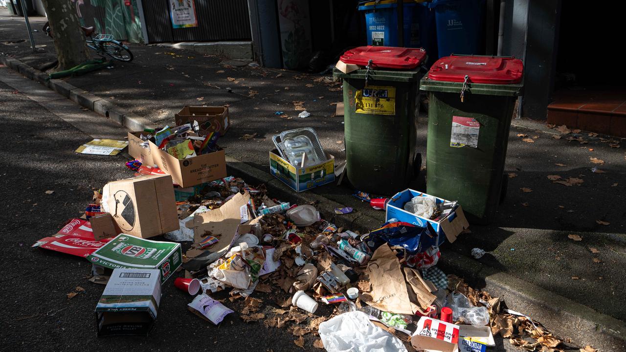 With bins lining the street inexplicably chained shut, gutters were filled with rubbish on Sunday morning. Picture: NCA NewsWire / Flavio Brancaleone