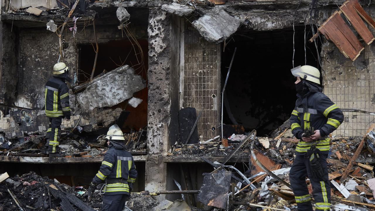 Firemen extinguish a fire inside a building damaged by a missile. Picture: Pierre Crom/Getty Images