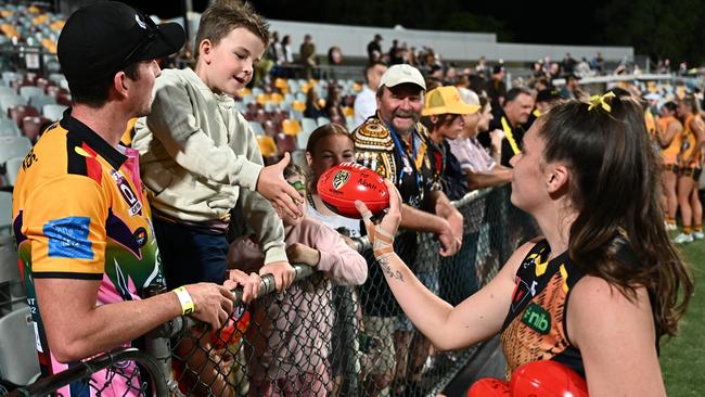 CAIRNS, AUSTRALIA - OCTOBER 20: Courtney Jones of the Tigers with supporters after the round eight AFLW match between Hawthorn Hawks and Richmond Tigers at Cazaly's Stadium, on October 20, 2023, in Cairns, Australia. (Photo by Emily Barker/Getty Images)