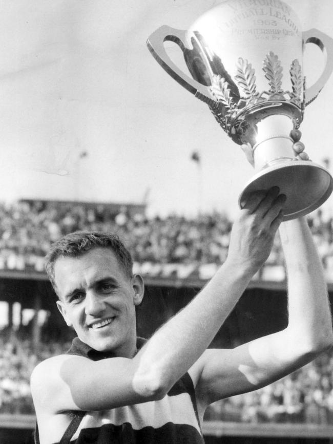 Geelong captain Fred Wooller holds up the cup.