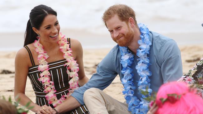 The Duke and Duchess of Sussex, Prince Harry and Meghan Markle visit Bondi beach to take part in the "Fluro Friday" yoga session. Members of the "Anti Bad Vibe Circle" sit on the sand  with the royal couple. Picture: Toby Zerna