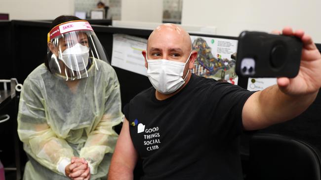 Mark Senjov celebrates his third Covid vaccination with selfie at the Ford hub with nurse immuniser Sara Cole. Picture: Alison Wynd