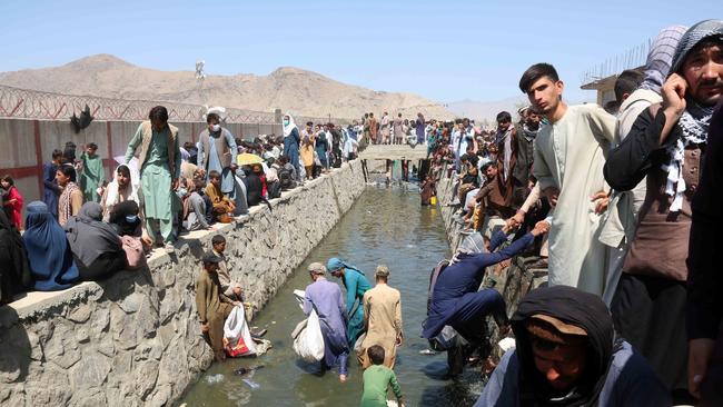 Afghans wade into the ditch outside Hamid Karzai International Airport, Kabul, Afghanistan, August 26. Picture: EPA/Akhter Gulfam