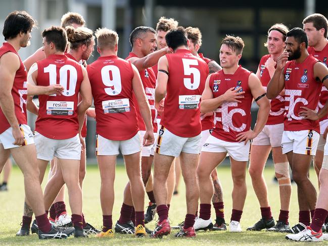 Daniel Kerr talks with his Tyabb teammates at half-time.