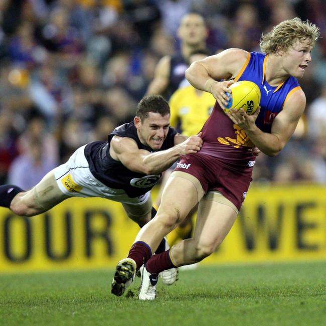 Daniel Rich attempts to break a Heath Scotland tackle. Picture: Darren England