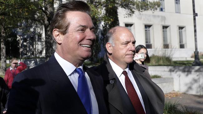 Paul Manafort, left, leaves the Federal District Court in Washington this morning.
