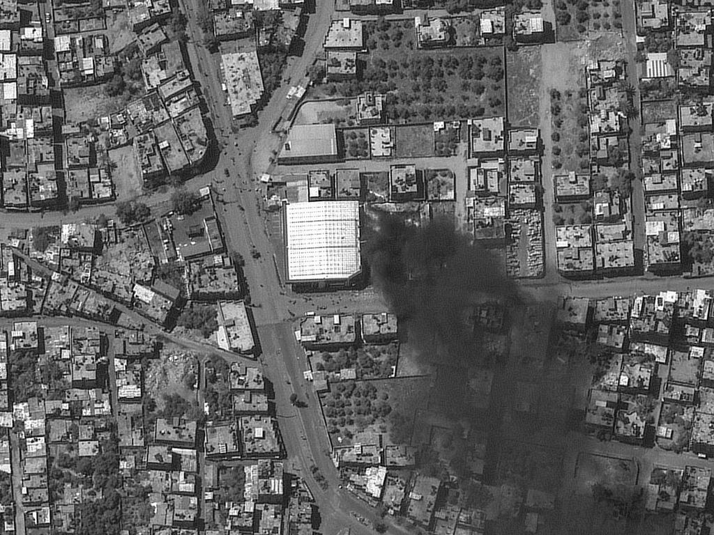 This handout image courtesy of Maxar Technologies taken by the WorldView-1 satellite on May 7, 2024 shows an aerial view of a burning building in Rafah in the southern Gaza Strip.