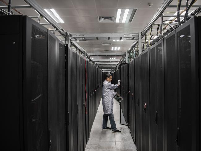 A Huawei engineer opens the door to a campus server unit. Picture: Getty