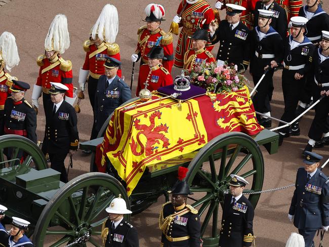 LONDON, ENGLAND - SEPTEMBER 19: The Queen's funeral cortege borne on the State Gun Carriage of the Royal Navy travels along The Mall on September 19, 2022 in London, England. Elizabeth Alexandra Mary Windsor was born in Bruton Street, Mayfair, London on 21 April 1926. She married Prince Philip in 1947 and ascended the throne of the United Kingdom and Commonwealth on 6 February 1952 after the death of her Father, King George VI. Queen Elizabeth II died at Balmoral Castle in Scotland on September 8, 2022, and is succeeded by her eldest son, King Charles III.  (Photo by Chip Somodevilla/Getty Images)