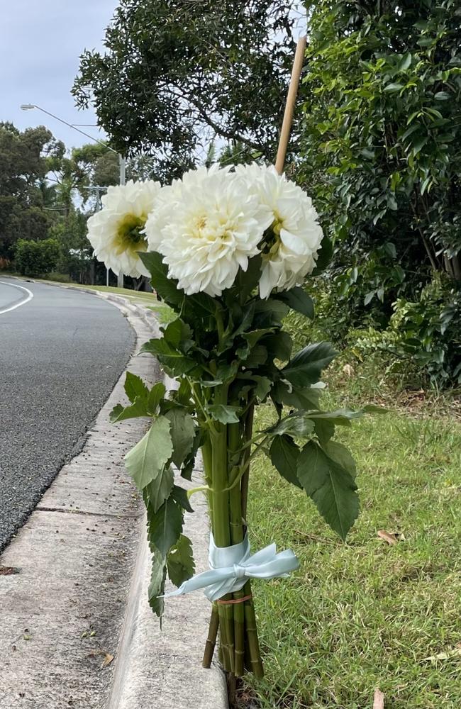 The family that lives opposite the crash put out flowers on Saturday morning.