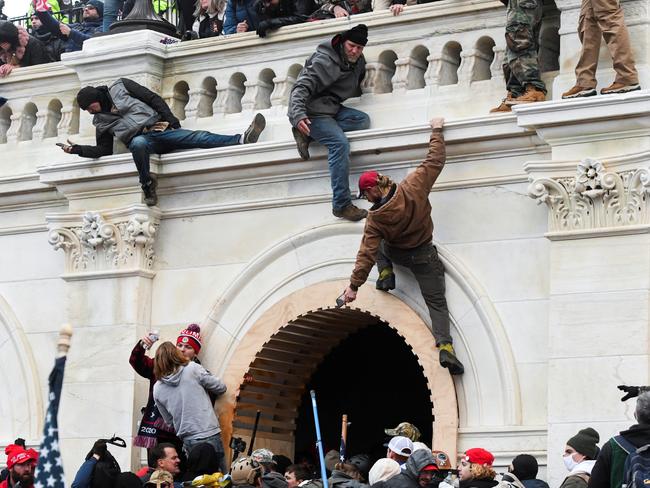 Trump supporters climb the walls of the Capitol building. Picture: Reuters