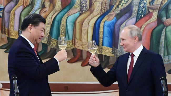 Vladimir Putin and China's President Xi Jinping make a toast during a reception following their talks at the Kremlin in March. Picture: Getty Images.