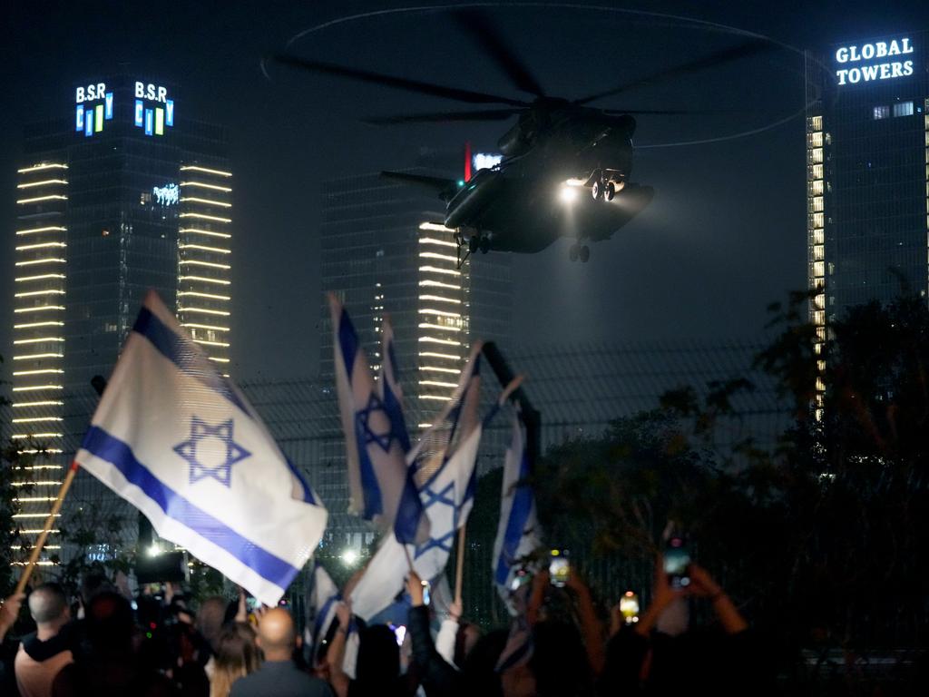 A helicopter is seen arriving with hostages at Schneider medical centre where they disembarked behind screens as family and friends wait nearby. Picture: Erik Marmor/Getty Images