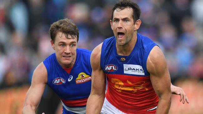 Luke Hodge evades Jack MacRae Brisbane’s loss to Western Bulldogs. Picture: Julian Smith